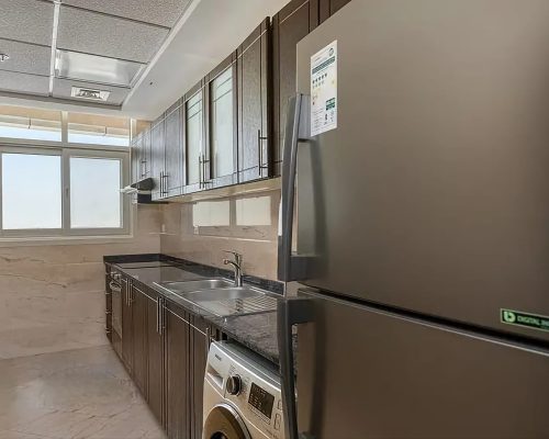 closed kitchen in a 2 bedroom apartment for sale in Siraj Tower Arjan Dubai