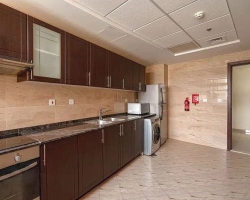 closed kitchen in a 3 bedroom flat for sale in Siraj Tower Arjan Dubai