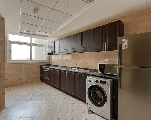 huge kitchen in a 3 bedroom apartment for sale in Siraj Tower Arjan Dubai